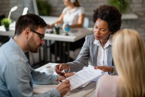 black female real estate agent showing couple where sign contract meeting office 637285 1743 black female real estate agent showing couple where sign contract meeting office 637285 1743